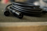 a couple of black wires sitting on top of a table