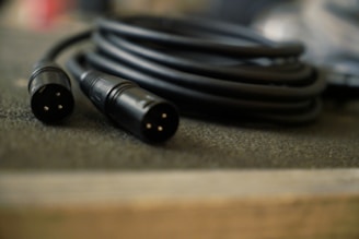 a couple of black wires sitting on top of a table