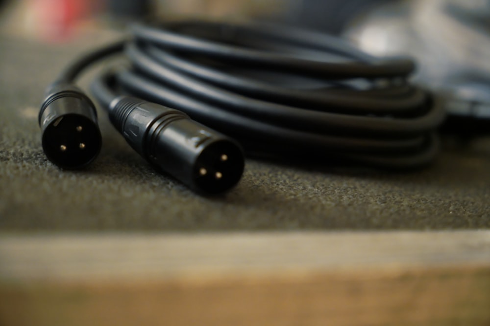 a couple of black wires sitting on top of a table