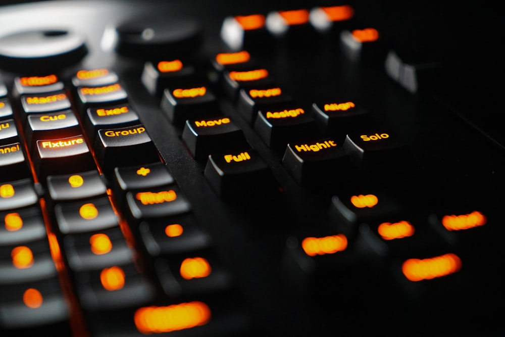 a close up of a black keyboard with orange keys