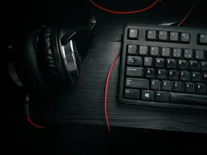 Stylish dark-themed setup with guitar, sheet music, and laptop open to a lesson.