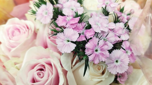 A lush bridal bouquet featuring soft pink roses and greenery.