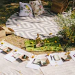 Elegant outdoor rug set up in a garden setting.
