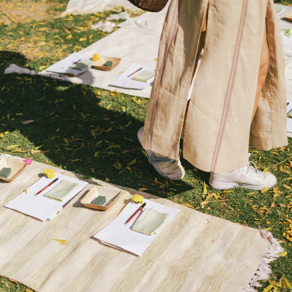a person standing next to a bunch of papers on the ground