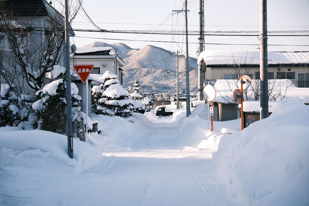 a snow covered street with a red stop sign