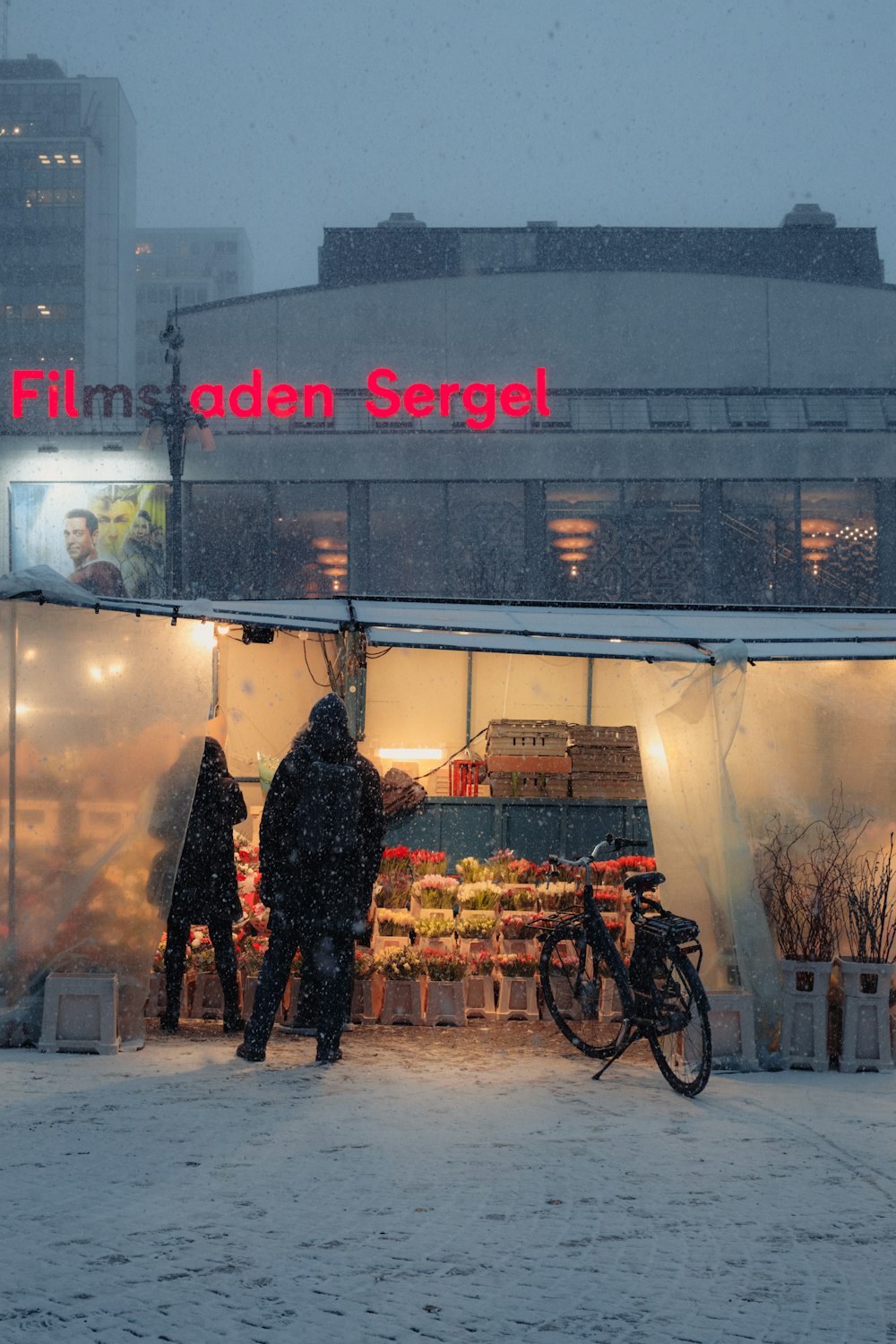 a couple of people standing outside of a store