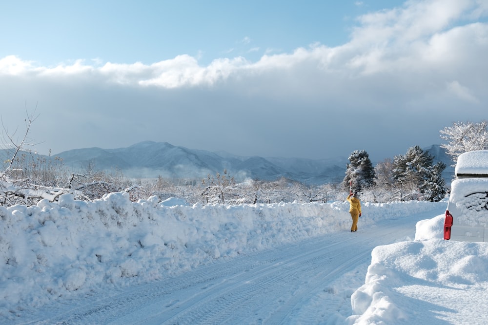 a person walking down a snow covered road