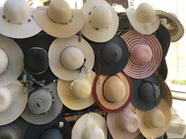 Variety of stylish hats hanging on a vintage wall rack