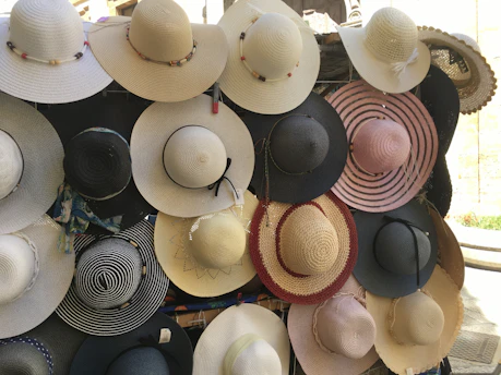 Variety of stylish hats hanging on a vintage wall rack