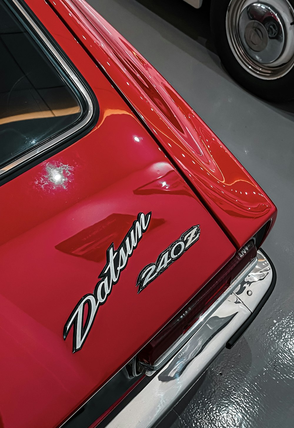 a close up of the tail end of a red car