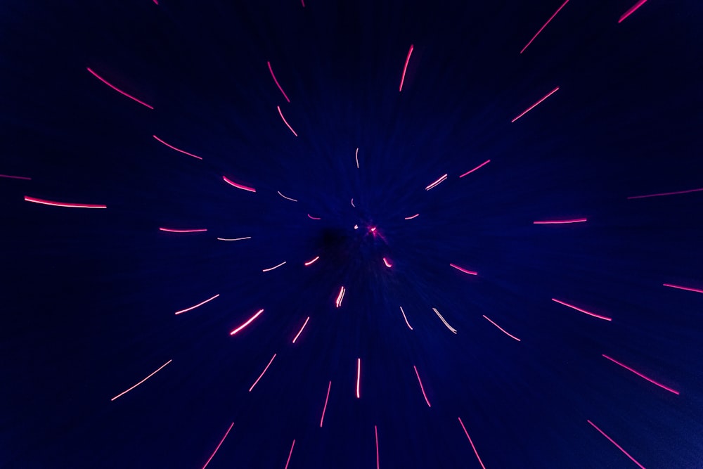a dark blue background with red and white fireworks