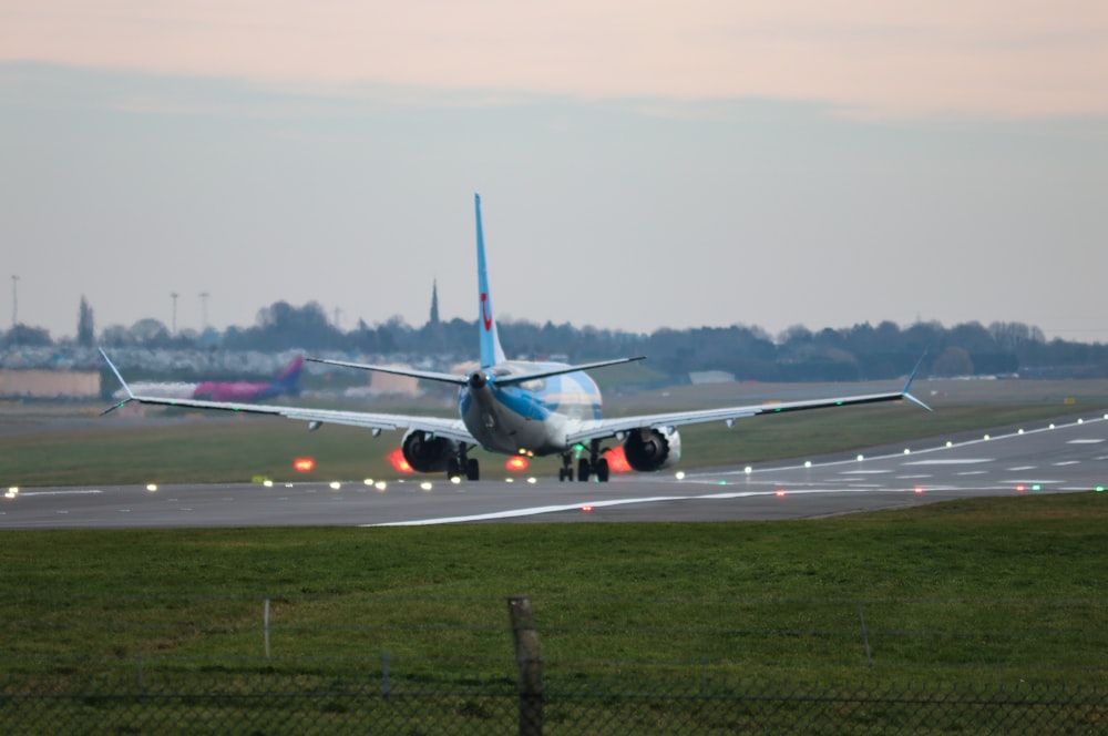 a large jetliner sitting on top of an airport runway