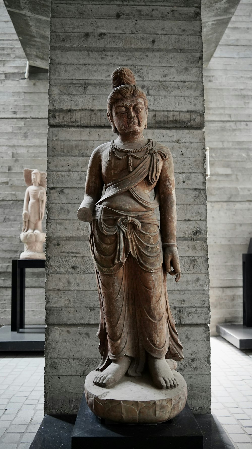 a statue of a buddha in a museum