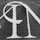 A section of textured black asphalt with large, white-painted letters. The letters have a serif style and a slightly worn-out appearance.
