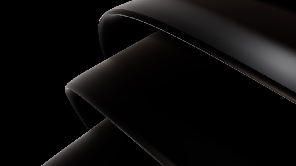 a close up of a black object on a black background