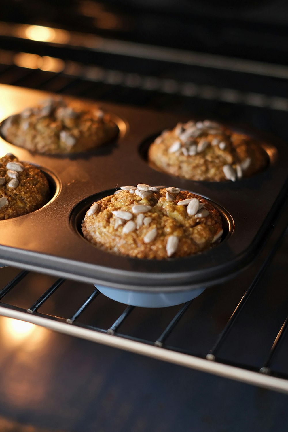 a muffin tin filled with muffins sitting on top of an oven
