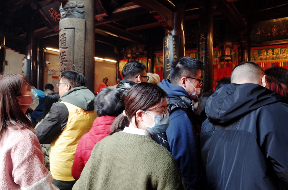 a group of people standing in line at a temple