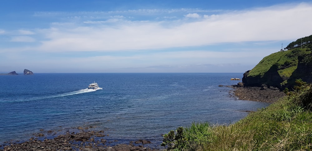 a boat is out in the ocean on a sunny day