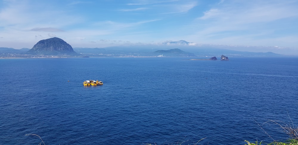 a small boat floating on top of a large body of water