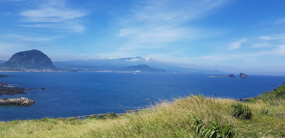 a scenic view of a body of water with mountains in the background