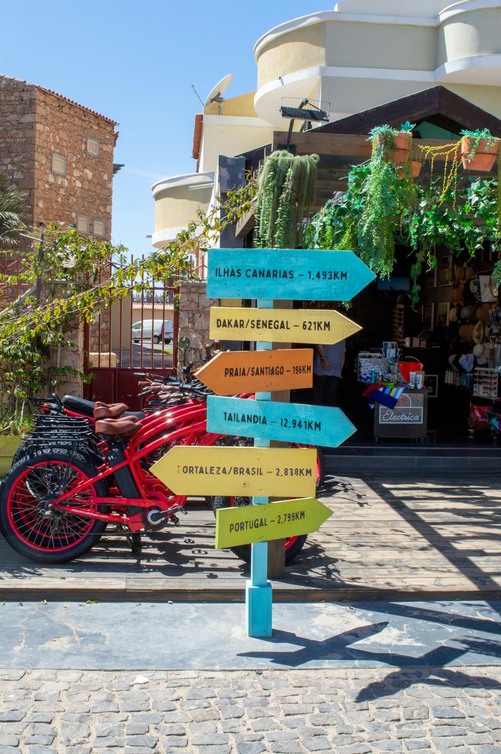 a red bike is parked next to a sign