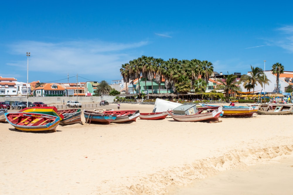 a group of boats sitting on top of a sandy beach