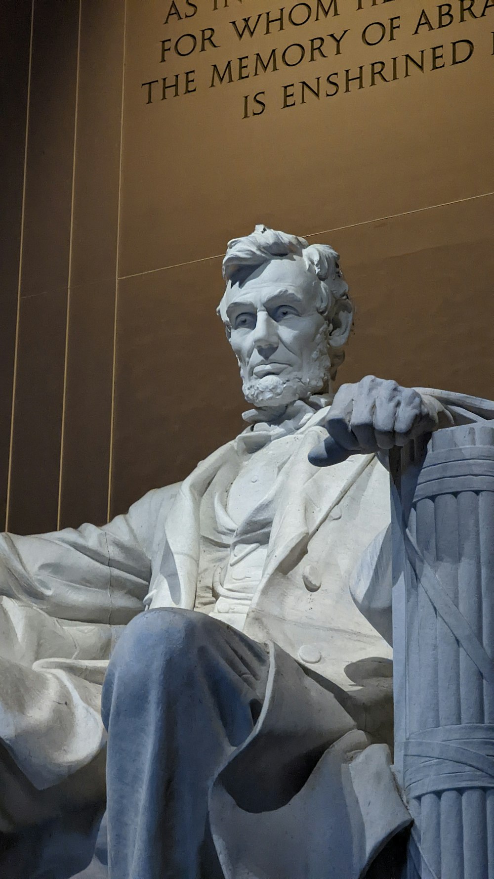 a statue of abraham lincoln in front of the lincoln memorial