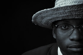 a man wearing a straw hat and glasses