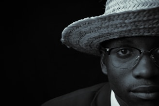 a man wearing a straw hat and glasses