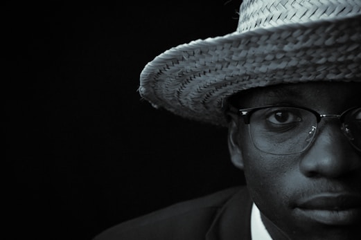 a man wearing a straw hat and glasses