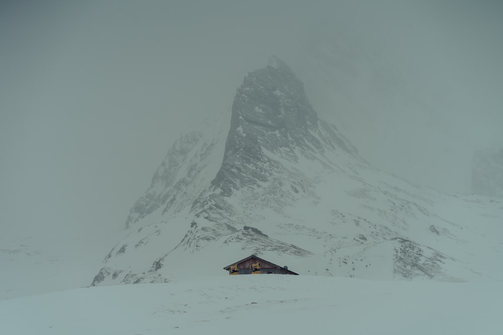 a house in the middle of a snow covered mountain