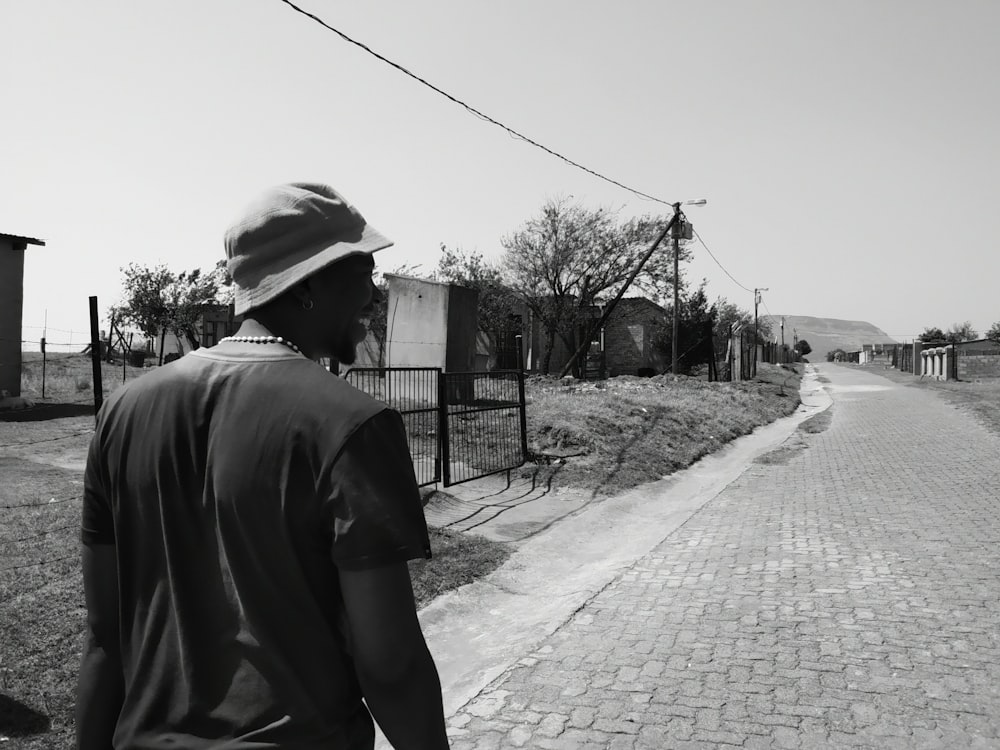 a man is walking down a brick road