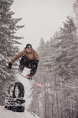 Snowboarders performing tricks in the snow.