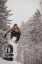 Group of young snowboarders learning tricks on boxes and jumps.
