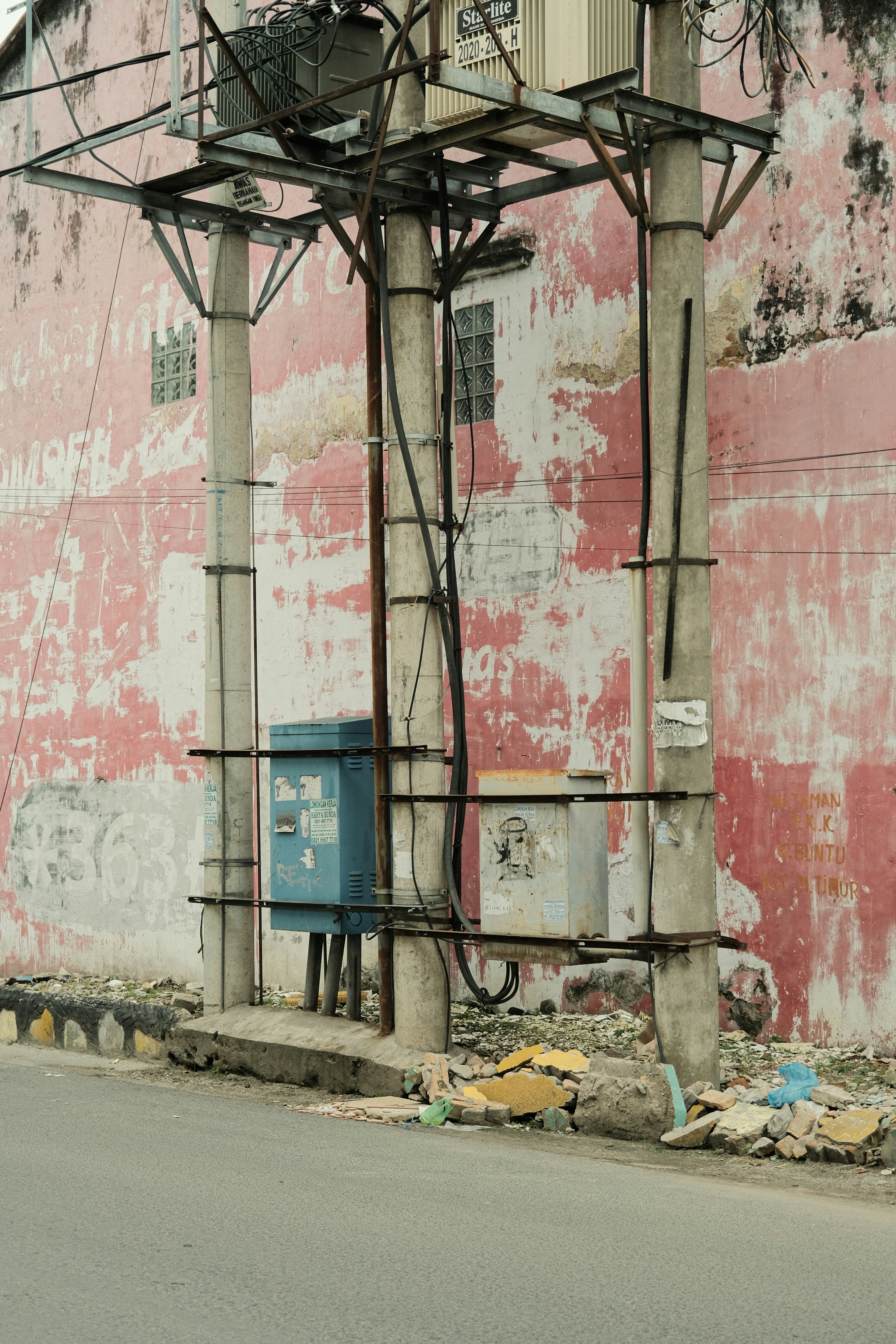 an old building with a telephone pole on the side of it