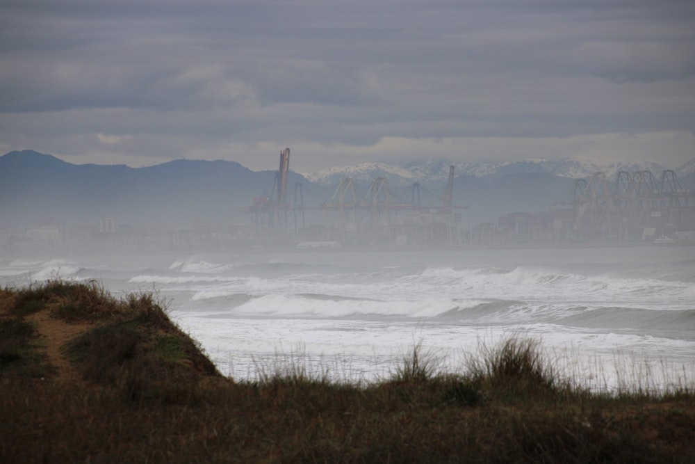 a view of a large body of water with mountains in the background