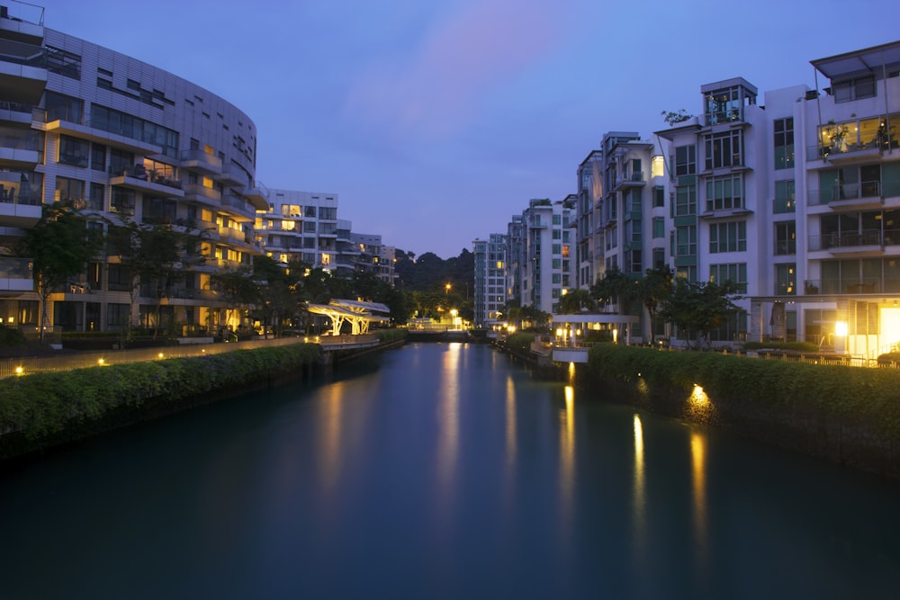 a river running through a city next to tall buildings