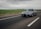 Image of a sleek modern muscle car cruising on an open highway post-tune.