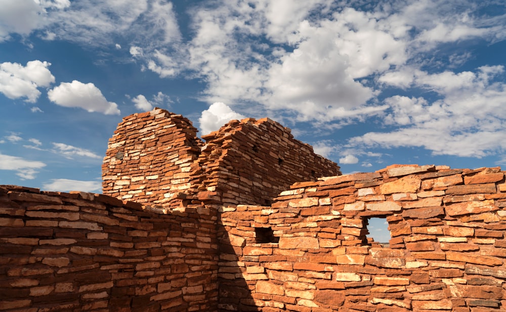 a brick building with a sky background