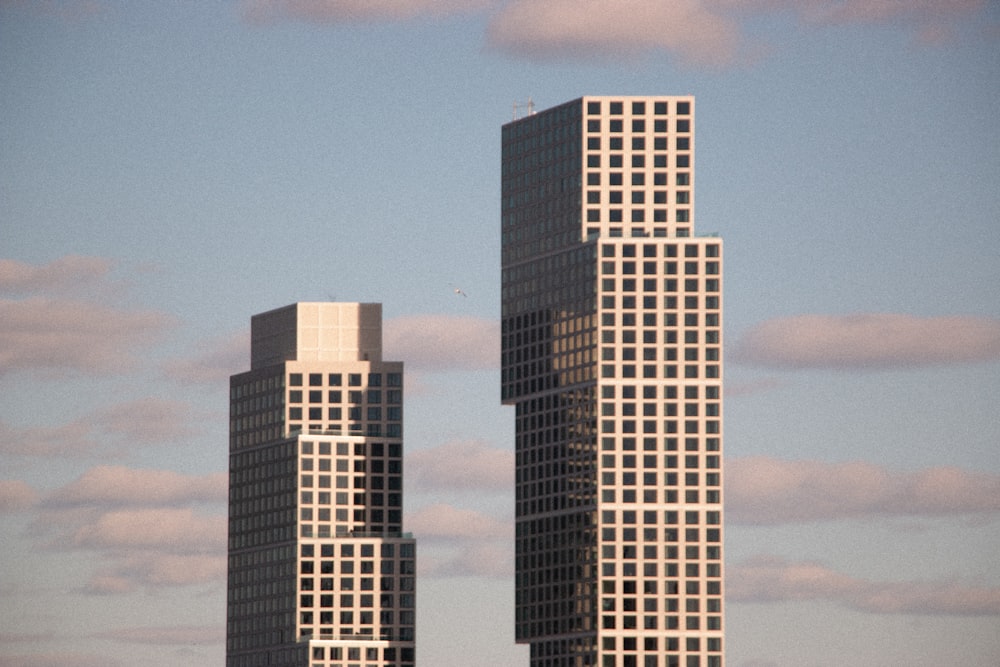 a couple of tall buildings sitting next to each other