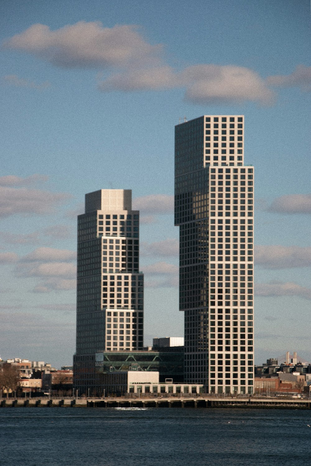 a large body of water in front of two tall buildings