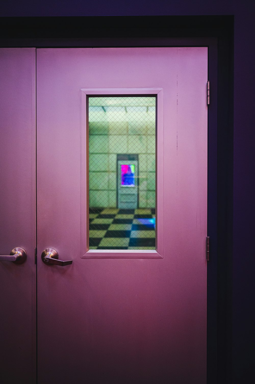 a purple door with a small window in it