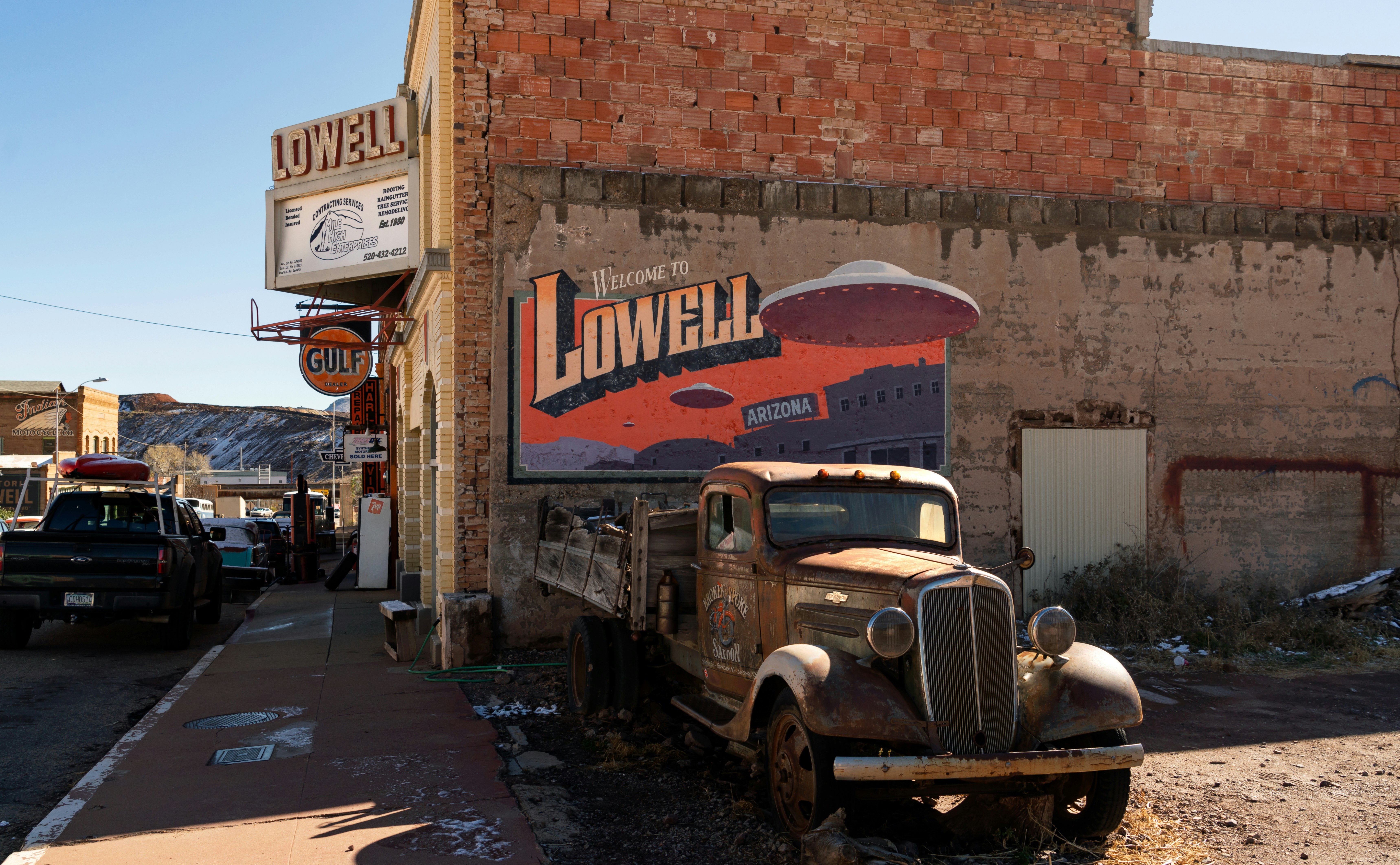an old truck parked in front of a building, An old Chevrolet truck parked in the Lowell Theater parking lot in Lowell, Arizona