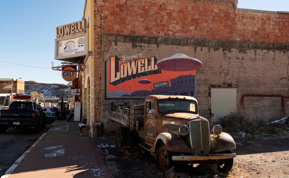 an old truck parked in front of a building