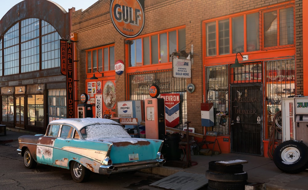 an old car parked in front of a building