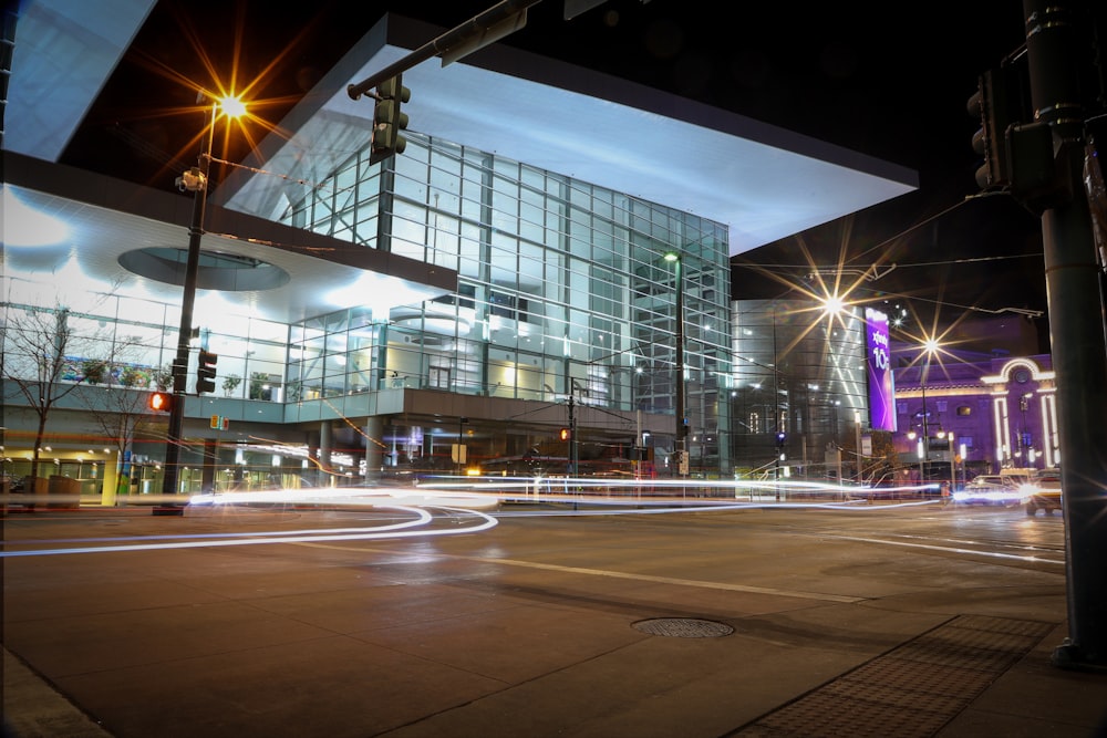 a city street at night with a building in the background