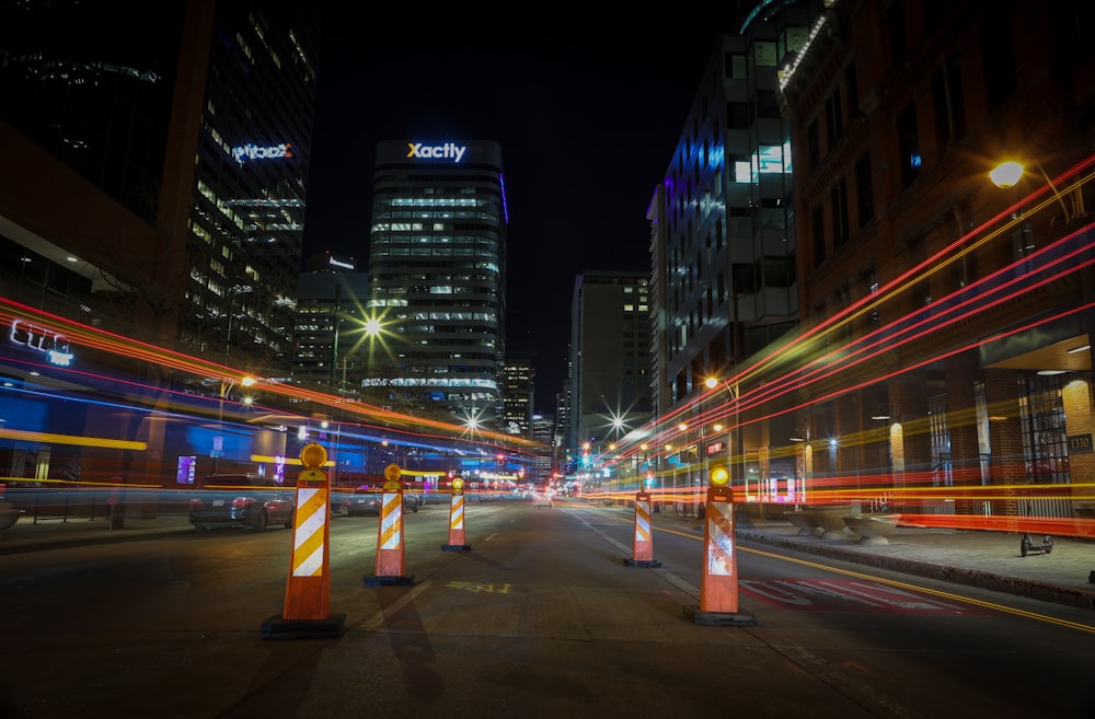 a city street at night with traffic lights