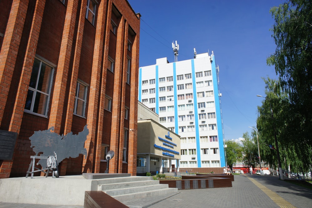 a large building with a blue and white building in the background