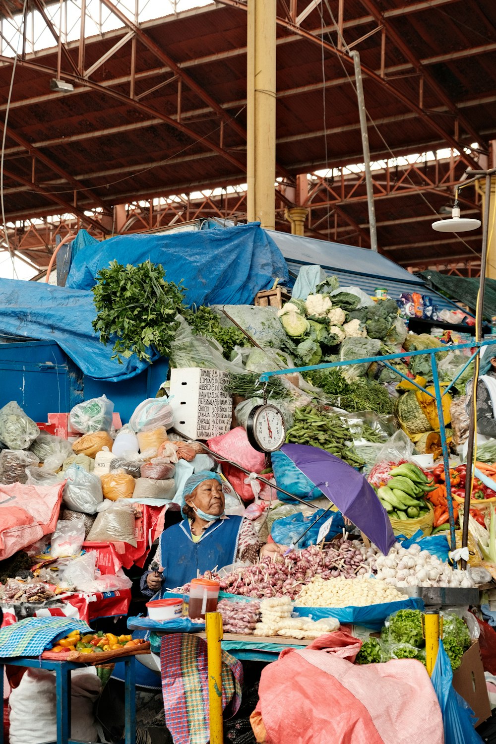 a large pile of vegetables and fruits in a warehouse