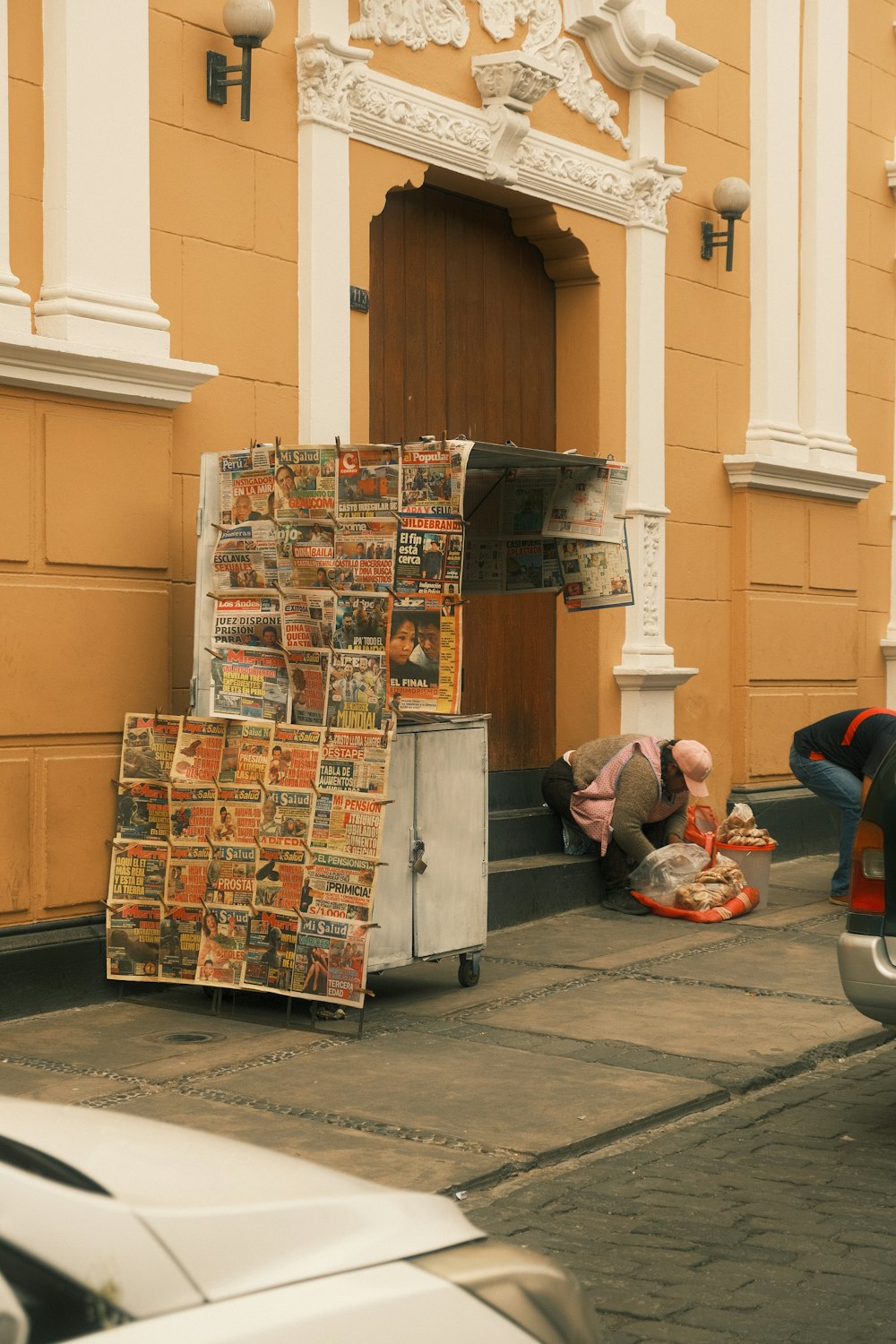 a person laying on the ground in front of a building